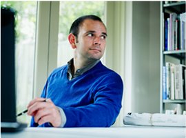 Small business owner sitting at his desk